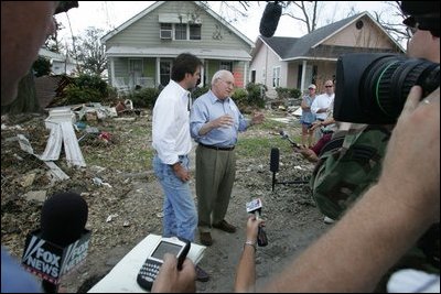 Vice President Dick Cheney walks with Mayor Gregg Warr, Thursday, Sept. 8, 2005, through a neighborhood in Gulfport, Miss., devastated by Hurricane Katrina, as they talk with surviving residents.