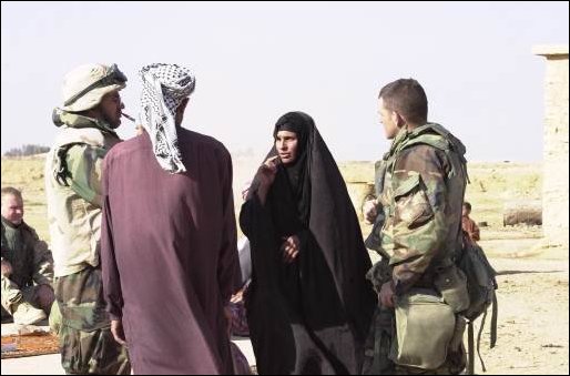  Staff SGt. Robert Laverick (R) of the 422d Civil Affairs Battalion, Greensboro, N.C., talks to a local woman.