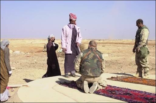 US soldiers meet with a local family.