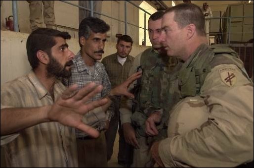 U.S. Army Lt. Col. Tracy Wright of the 308th Civil Affairs Brigade speaks to a civil engineer in Ramatha, Iraq, on April 9, 2003. Lt. Col. Wright is gathering information that will help aide the Iraqi people improve its water efficiency and distribution. The U.S. Army Corps of Engineer and various Civil Affairs units are deployed in support of Operation Iraqi Freedom. 