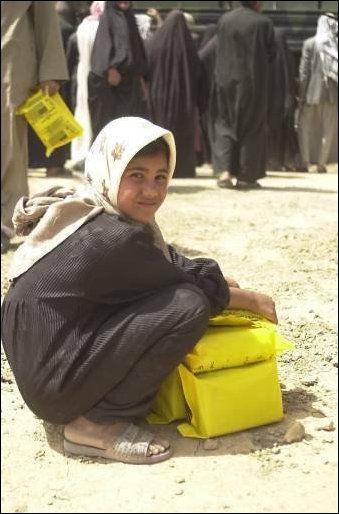 During a humanitarian aide mission by the U.S. Army, local civilians of As Samawa, Iraq, enjoy the abundance of rations given out on April 5, 2003. The 82nd Airborne Division is deployed in support of Operation Iraqi Freedom. (U.S. Army photo by Sgt. Kyran V. Adams) 