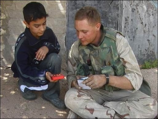 Northern Baghdad, IRAQ Marines from 2nd Battalion 5th Marines Regimental Combat Team Five (RCT 5) 1st MARDIV out of Camp Pendleton Calif., pause for a routine stop during a convoy. Lance Cpl. Shiloh S. Benton from Oneonta, N.Y. , interacts with a local civilian family during the convoy.