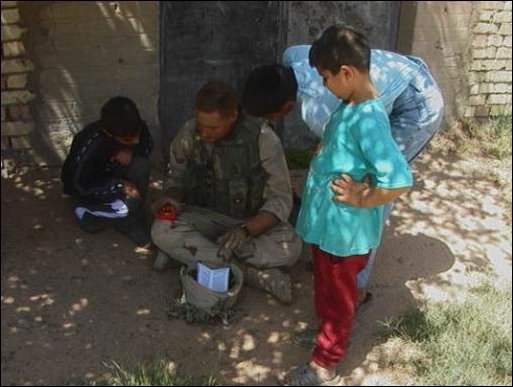 Children return to school in a village near the city of Najaf in central Iraq on April 4, 2003, for the first time since the war started. Soldiers from the 422nd Civil Affairs Battalion helped cleanup the school that was damaged by artillery fire. The soldiers also took money out of their own pockets to pay the teacher several months salary in advance. (U.S. Army photo by Staff Sgt. Kevin P. Bell.)