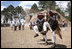 Joined by President Oscar Berger and his wife, Wendy Widmann de Berger, President George W. Bush and Mrs. Laura Bush enjoy a cultural dance Monday, March 12, 2007, during a visit to Iximche, Guatemala. White House photo by Paul Morse