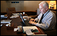 Bill McGurn, Assistant to the President for Speechwriting, works on his laptop aboard Air Force One Sunday, Jan. 13, 2008. White House photo by Eric Draper 