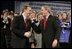 President George W. Bush shares a laugh with Dr. Jeffery Brown, Assistant Professor of the Finance Department at the University of Illinois at Urbana-Champaign, during a discussion on Social Security reform in Fargo, N.D., Thursday, Feb. 3, 2005. Also pictured, center, is conversation participant Mary Bond, a retired worker.