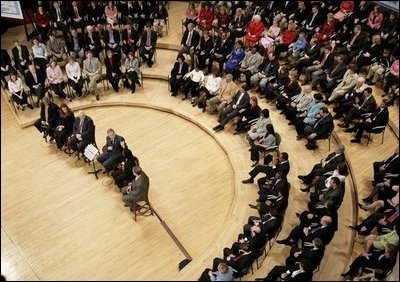 President George W. Bush talks with his fellow stage participants during his Town Hall meeting on strengthening Social Security in Raleigh, N.C., Thursday, Feb. 10, 2005.