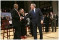 President George W. Bush greets his fellow stage participants during a Town Hall meeting on strengthening Social Security in Raleigh, N.C., Thursday, Feb. 10, 2005.