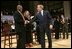 President George W. Bush greets his fellow stage participants during a Town Hall meeting on strengthening Social Security in Raleigh, N.C., Thursday, Feb. 10, 2005.