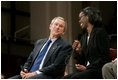 President George W. Bush and Dawn Baldwin, an English teacher at Lenior Community College in Kinston, N.C., exchange smiles during a town hall meeting on strengthening Social Security in Raleigh, N.C., Thursday, Feb. 10, 2005.