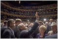 President George W. Bush waves to people in the balconies after participating in a conversation on strengthening Social Security at the Cannon Center for the Performing Arts in Memphis, Tenn., Friday, March 11, 2005.