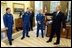 President George W. Bush shares a laugh with members of the International Space Station Expedition 6 Crew during their photo opportunity in the Oval Office Wednesday, Oct. 1, 2003. From left, are, Russian Flight Engineer Nikolai Budarin, Science Officer Donald Pettit, and Commander Kenneth Bowersox. Also pictured in background is NASA Administrator Sean O'Keefe.