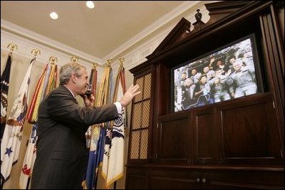 President George W. Bush smiles as he waves goodbye to the crew of the Space Shuttle Discovery Tuesday, Aug. 2, 2005, during a phone call from the Roosevelt Room of the White House. Before bidding the crew Godspeed and telling them to "get back to work," the President thanked them for being "risk-takers for the sake of exploration."