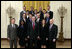 President George W. Bush stands with crew members of the Space Shuttle Discovery, the Space Shuttle Atlantis and the Space Station Expeditions 11, 12, and 13 Monday, Oct. 23, 2006, in the East Room of the White House. With the President in the front row, from left, are: Col. Steve Lindsey, Stephanie Wilson, Cmdr. Lisa Nowak, and Cmdr. Mark Kelly. Second row: Steven MacLean, Capt. Chris Ferguson, Col. Jeff Williams and Mike Fossum. Third row: Cmdr. Heidemarie Stefanyshyn-Piper, Cmdr. Dan Burbank and Dr. Piers Sellers. Top row: Capt. Brent Jett, Jr., Col. Bill McArthur, Jr. and Joe Tanner. 