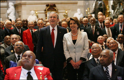 President George W. Bush and Speaker of the House Nancy Pelosi join 300 Tuskegee Airmen in Statuary Hall at the U.S. Capitol for a photograph Thursday, March 29, 2007. The group photo was part of the Congressional Gold Medal ceremony honoring America’s first African-American military airmen. White House photo by Eric Draper