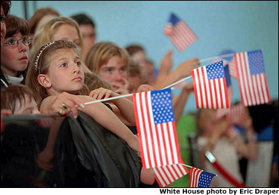 Children listen to President Bush and Mrs. Bush during their remarks at an American school in Brussels, June 13, 2001. White House photo by Eric Draper.