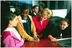 Lynne Cheney talks with 5th grade students Ashley Giorgio, left, and Anasha Segers, center, while they wait to take a seat on the Supreme Court Bench at the the National Constitution Center in Philadelphia Wednesday, Sept. 17, 2003.