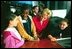 Lynne Cheney talks with 5th grade students Ashley Giorgio, left, and Anasha Segers, center, while they wait to take a seat on the Supreme Court Bench at the the National Constitution Center in Philadelphia Wednesday, Sept. 17, 2003.