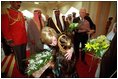 Two children greet Vice Present Dick Cheney and Mrs. Cheney with bouquets of flowers upon their arrival at Dasman Palace in Kuwait City, Kuwait, March 18. 