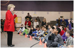 Students at Fort Belvoir Elementary School fill the gymnasium Tuesday, Dec. 13, 2005, for a visit by Mrs. Lynne Cheney. Mrs. Cheney spoke with the kids about the importance of the upcoming Iraqi elections and likened the parliamentary procedure to that of America's in its own early struggle for democracy.