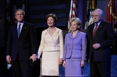 President George W. Bush stands with Laura Bush, Lynne Cheney and Vice President Dick Cheney during the pre-inaugural event “Saluting Those Who Serve” at the MCI Center in Washington, D.C., Tuesday Jan. 18, 2005.