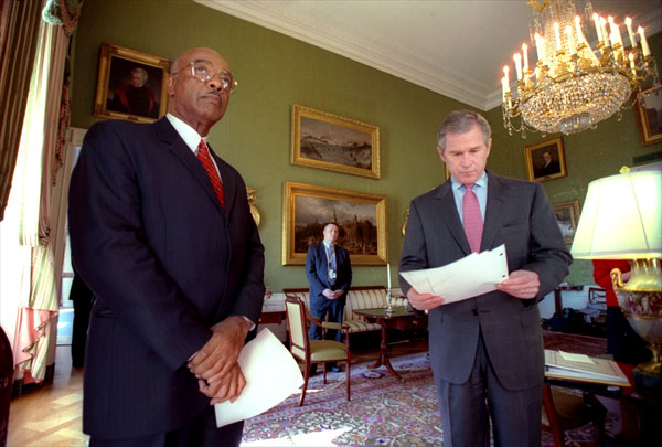 Just before announcing his new education plan, President George W. Bush reads over his speech in the Green Room Jan. 23, 2001. The President is accompanied by Rod Paige, his choice as the next Secretary of Education. White House photo by Eric Draper