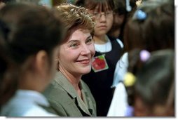 Mrs. Bush is surrounded by students after reading to them in the library of Morningside Elementary School in San Fernando, Calif., March 22, 2001.  White House photo by Paul Morse