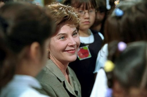 Mrs. Bush is surrounded by students after reading to them in the library of Morningside Elementary School in San Fernando, Calif., March 22, 2001. White House photo by Paul Morse.