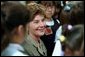 Mrs. Bush is surrounded by students after reading to them in the library of Morningside Elementary School in San Fernando, Calif., March 22, 2001. White House photo by Paul Morse.