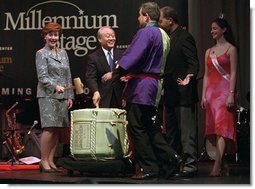 Laura Bush shares the Millennium Stage at the Kennedy Center with Japan’s ambassador Shunji Yanai and Washington, D.C. Mayor Anthony Williams and others during the 2001 Cherry Blossom Festival in Washington, D.C. March 25, 2001.  White House photo by Paul Morse