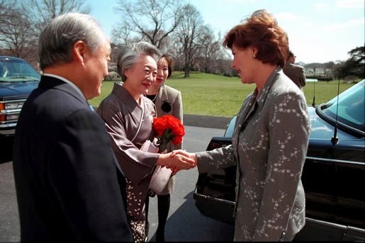 Laura Bush greets Ambassador and Mrs. Shunji Yanai of Japan before departing for the 2001 Cherry Blossom Festival March 25, 2001. White House photo by Paul Morse.