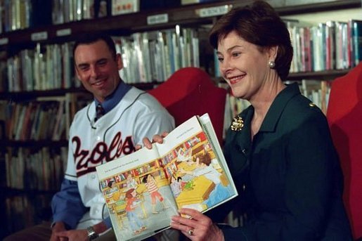 Laura Bush and Baltimore Orioles shortstop, Mike Bordick, read to children at the Washington, D.C. Public Library, Northeast Branch, as part of “Celebrate National Library Week at your Library” April 3, 2001. White House photo by Eric Draper.