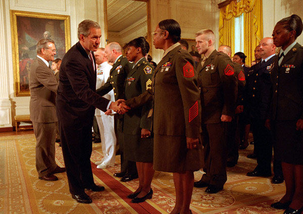 President George W. Bush and Secretary of Defense Donald H. Rumsfeld congratulate re-enlistees at the White House Wednesday, May 23. WHITE HOUSE PHOTO BY ERIC DRAPER