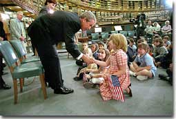 Welcomed by leaders both tall
and small, President Bush and First Lady Laura Bush visit the reading
room at the British Museum July 19, 2001. White House photo by Eric
Draper.