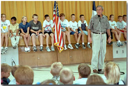 During an impromptu visit to Crawford Elementary School Aug. 23, President Bush fielded a variety of question from inquisitive students who wanted to know what is it like being President, where the White House is located, how old the President is and what he scored in a recent round of golf. "Too high to count," replied President Bush laughing. White House photo by Moreen Ishikawa.