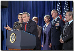 With Secretary of Defense, Donald Rumsfeld by his side, President Bush announces that General Richard B. Myers, center, will be the Chairman of the Joint Chiefs and General Pete Pac, far left, will serve as Vice Chairman of the Joint Chiefs during a press briefing at the Crawford Community Center, Aug. 24. White House photo by Moreen Ishikawa.