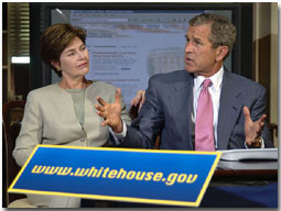 Guided by White House
Webmaster Jane Cook (not pictured), President Bush and First Lady Laura
Bush tour through the new, restructured White House website in the
historic Dwight D. Eisenhower Executive Office Building Library Aug.
31. The new site is more accessible for the disabled community, photo
essays, a Spanish section and a kids' page. White House photo by Eric
Draper.