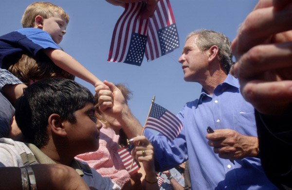 President George W. Bush greets the families of Michigan Teamster Union members during a Labor Day Barbecue at Teamsters Headquarters in Detroit, Michigan, Sept. 3, 2001. WHITE HOUSE PHOTO BY ERIC DRAPER.