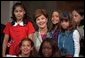 Laura Bush poses with children participating the National Book Festival Back to School event in the Great Hall at the Library of Congress Jefferson Building Sept. 7, 2001 in Washington, D.C. White House photo by Moreen Ishikawa.