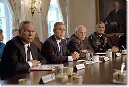 Accompanied by Secretary of State Colin Powell, far left, Vice President Dick Cheney and Chairman of the Joint Chiefs of Staff Hugh Shelton (far right), President George W. Bush talks with the press about the previous day's terrorist attacks during a cabinet meeting Sept. 12, 2001. White House photo by Tina Hager.