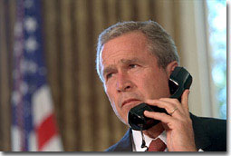 Pledging support for New York, President George Bush talks with Governor George Pataki and Mayor Rudolph Giuliani in a televised telephone conversation from the Oval Office Sept. 13. "Mr. President, you would be proud of the leadership and the cooperation we've seen here," said the governor. White House photo by Eric Draper.