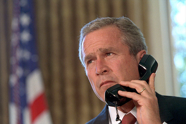 Pledging support for New York, President George Bush talks with Governor George Pataki and Mayor Rudolph Giuliani in a televised telephone conversation from the Oval Office Sept. 13. "Mr. President, you would be proud of the leadership and the cooperation we've seen here," said the governor. White House photo by Eric Draper.