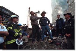 Standing upon the ashes of the worst terrorist attack on American soil, Sept. 14, 2001, President Bush pledges that the voices calling for justice from across the country will be heard. Responding to the Presidents' words, rescue workers cheer and chant, "U.S.A, U.S.A." White House photo by Eric Draper