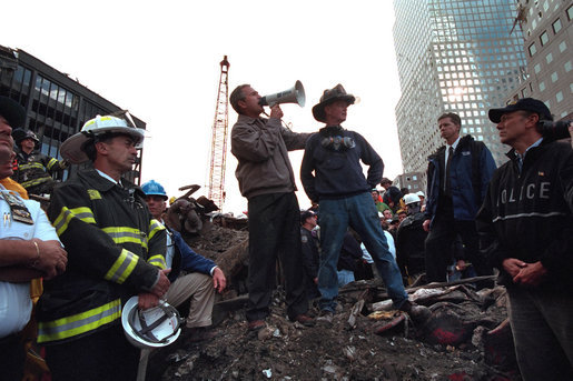 Standing upon the ashes of the worst terrorist attack on American soil, Sept. 14, 2001, President Bush pledges that the voices calling for justice from across the country will be heard. Responding to the Presidents' words, rescue workers cheer and chant, "U.S.A, U.S.A." White House photo by Eric Draper