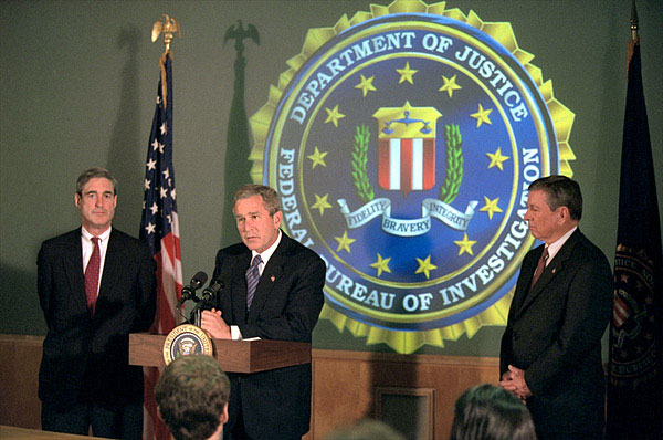 President Bush addresses the media during a tour of FBI headquarters with director Robert Mueller, left, and Attorney General John Ashcroft Sept. 25. The President visited the offices to personally thank employees for their recent and contined efforts since the Sept. 11 attack. White House photo by Paul Morse.