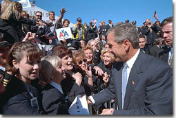 Greeted by a roaring crowd of good cheer, President Bush visits with Arline employees at Chicago's O'Hare International Airport Sept. 27. "And one of the great goals of this nation's war is to restore public confidence in the airline industry," said the President explaining that his staff flew on commercial airplanes for the Midwest meeting. White House photo by Eric Draper.