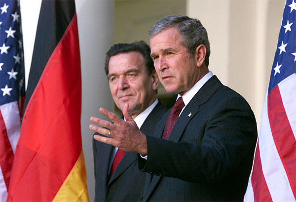 White House photo by Paul Morse. President George Bush and Germany's Chancellor Gerhard Schroeder address the media from the White House steps in the Rose Garden Oct 9.