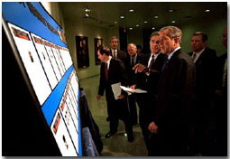 White House photo by Eric Draper. President George W. Bush looks over the newly created list of Most Wanted Terrorists with FBI Director Rober Mueller at the agency's headquarters Oct. 10.