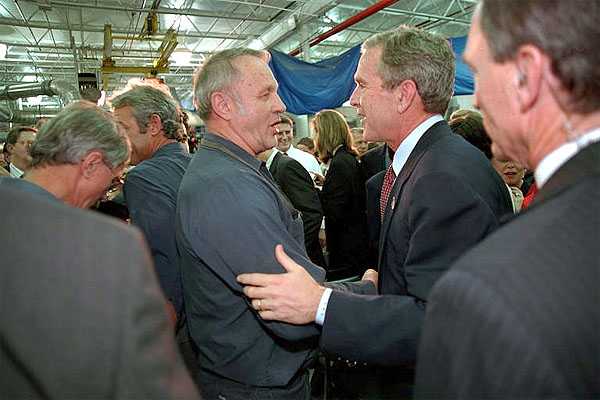 President George W. Bush wades into the crowd after speaking to Employees at the Dixie Printing Company in Glen Burnie, Md, Oct. 24. White House photo by Eric Draper.