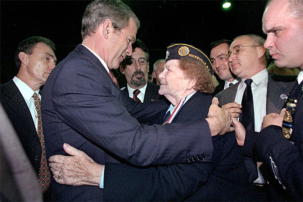 Attending the Veterans Day Prayer Breakfast at Park Avenue Seventh Regiment Armory in New York Nov. 11, President George W. Bush embraces Arlene Howard, who gave President Bush the badge from her son, George Howard, a Port Authority police officer who died at the World Trade Center. White House photo by Paul Morse.